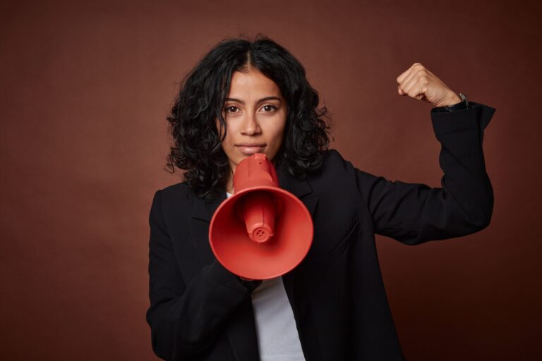 A,Young,Business,Woman, with megaphone, Passionately,Advocates,For,Her,Rights,With